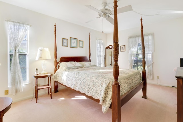 bedroom featuring ceiling fan and light carpet