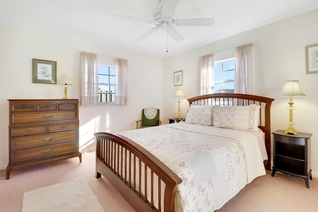 bedroom featuring light colored carpet and ceiling fan