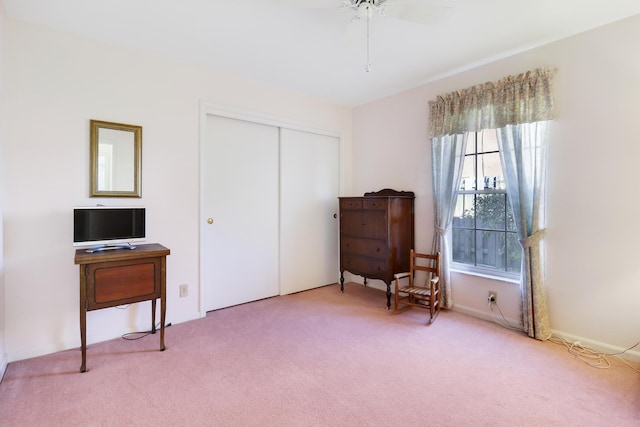 sitting room featuring carpet and ceiling fan