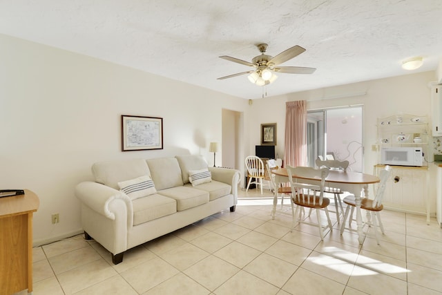 living room featuring ceiling fan and light tile patterned floors