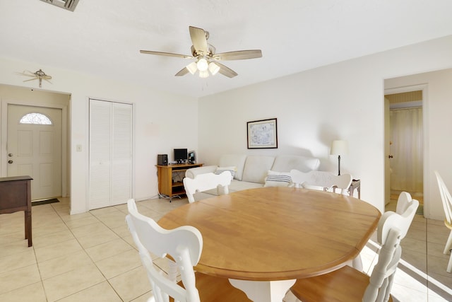 tiled dining space with ceiling fan