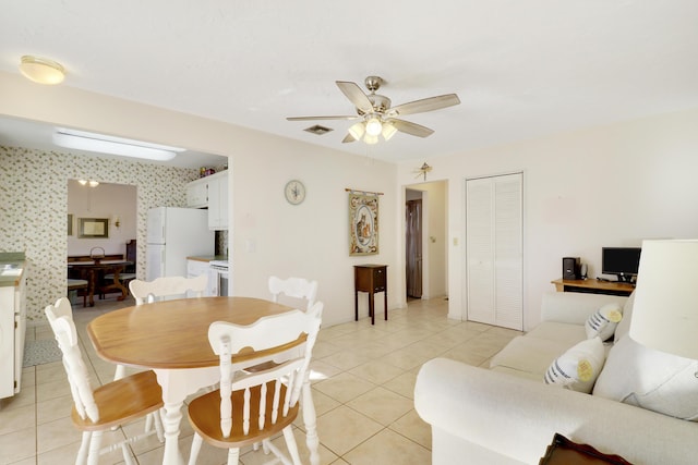 dining room with light tile patterned floors and ceiling fan