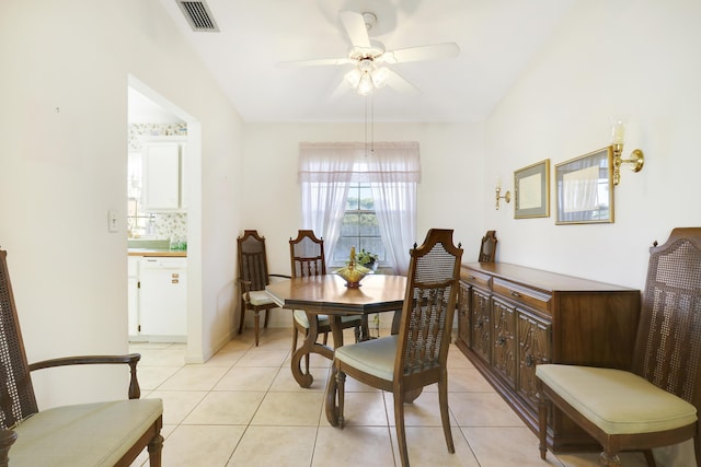 dining space featuring light tile patterned floors, vaulted ceiling, and ceiling fan