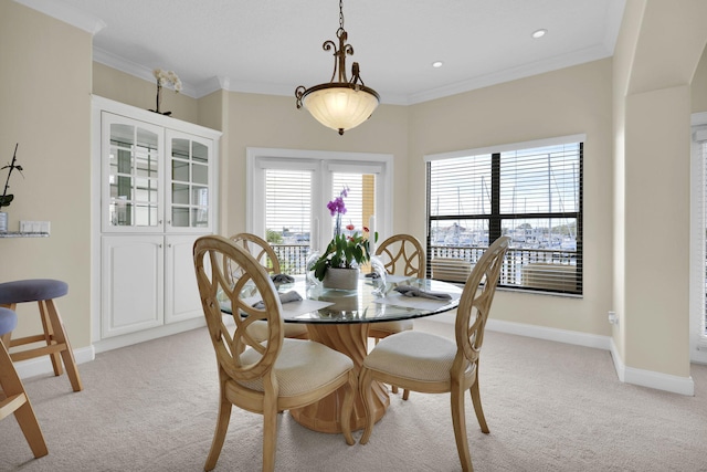 dining room featuring recessed lighting, light colored carpet, crown molding, and baseboards