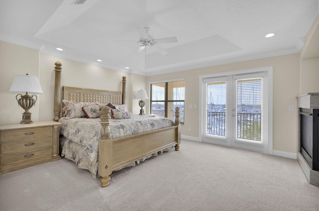 bedroom with light carpet, crown molding, a raised ceiling, and access to exterior