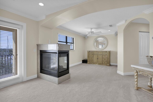 bedroom featuring access to exterior, light carpet, a tray ceiling, ceiling fan, and crown molding