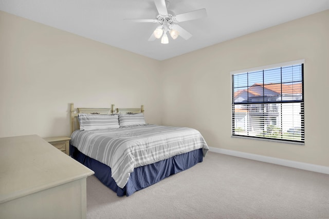 bedroom with a ceiling fan, baseboards, and carpet flooring