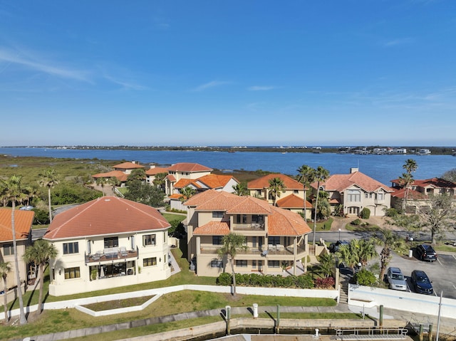 drone / aerial view with a water view and a residential view