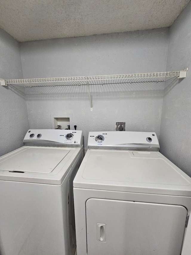 laundry area featuring washing machine and clothes dryer