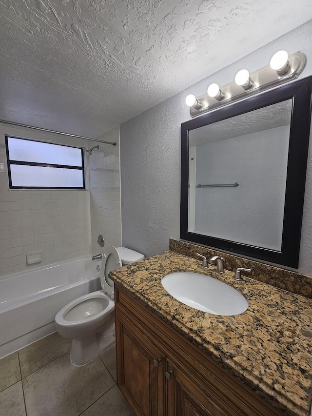 full bathroom featuring tile patterned floors, vanity, a textured ceiling, tiled shower / bath combo, and toilet