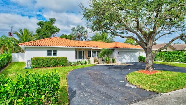 view of front of property with a front yard and a garage