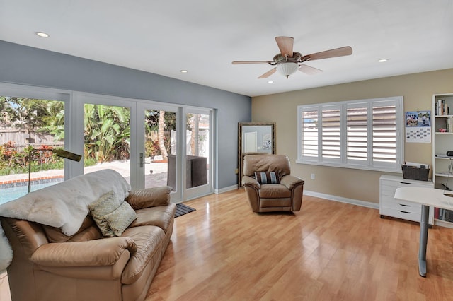 living room featuring ceiling fan, french doors, and light hardwood / wood-style flooring