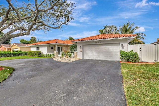 view of front of property featuring a front yard and a garage