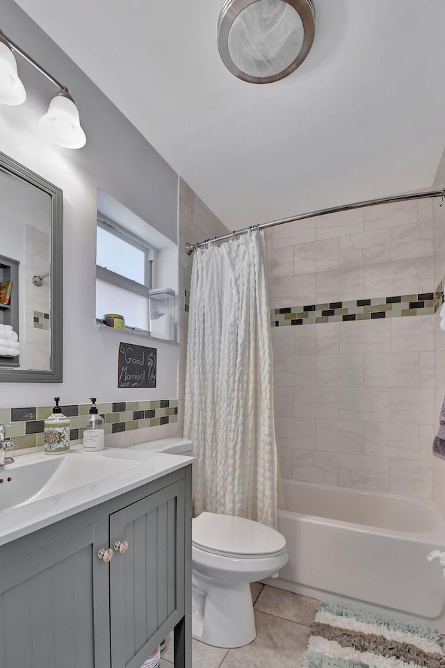 full bathroom featuring toilet, backsplash, tile patterned floors, shower / bath combo, and vanity