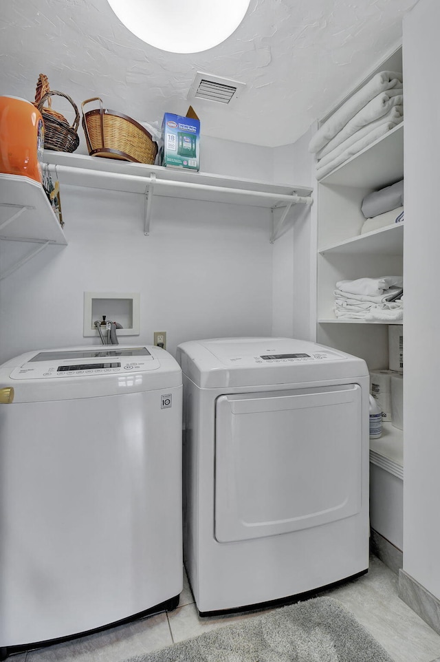 clothes washing area with washer and clothes dryer