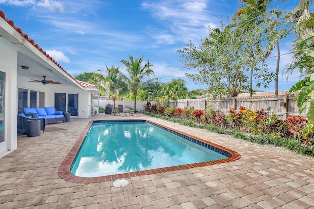 view of swimming pool featuring ceiling fan, a patio, and outdoor lounge area