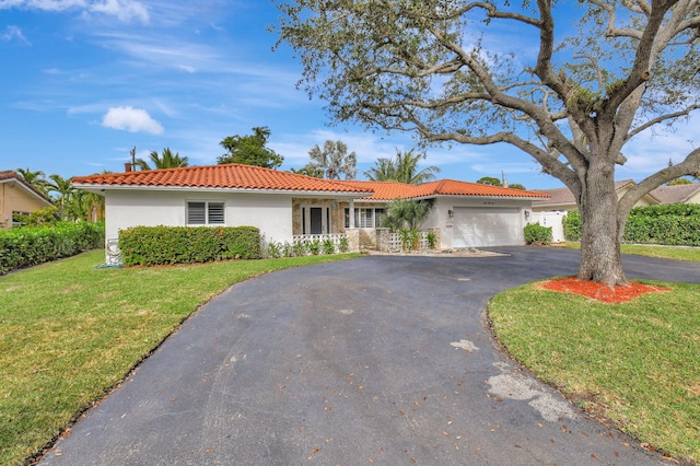 view of front of house with a garage and a front lawn