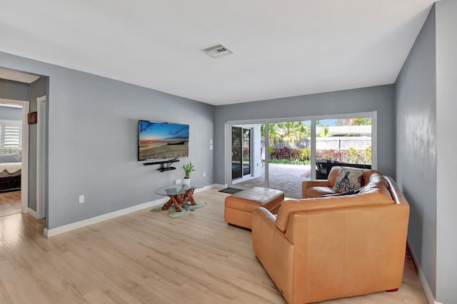 living room with light hardwood / wood-style flooring