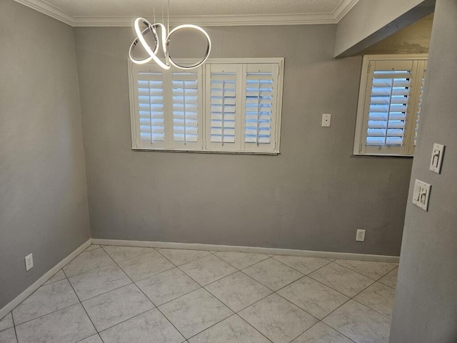 empty room with light tile patterned floors, crown molding, and a chandelier