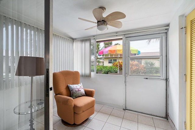 sunroom featuring ceiling fan