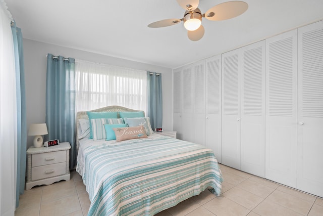 bedroom featuring light tile patterned flooring and ceiling fan