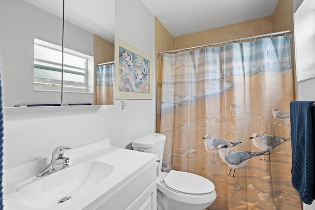 bathroom with toilet, a shower with shower curtain, and vanity