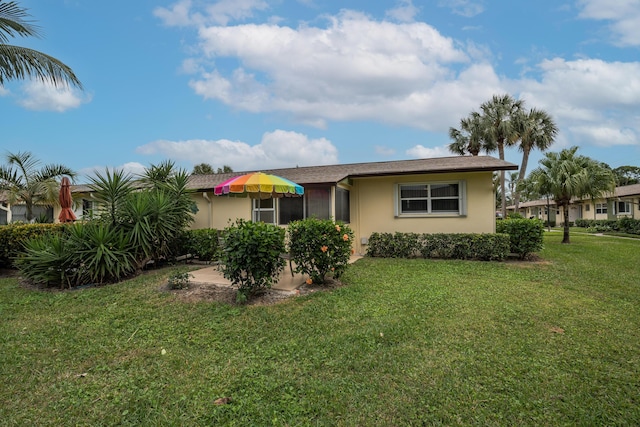 ranch-style home with a front lawn