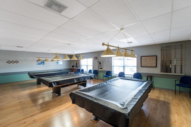 game room with pool table, a paneled ceiling, and hardwood / wood-style floors