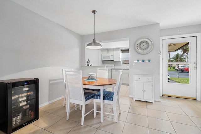 dining space with beverage cooler and light tile patterned flooring