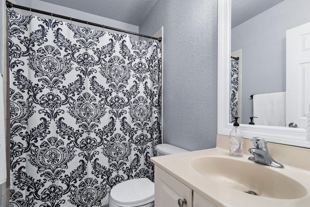 bathroom featuring vanity, curtained shower, and toilet