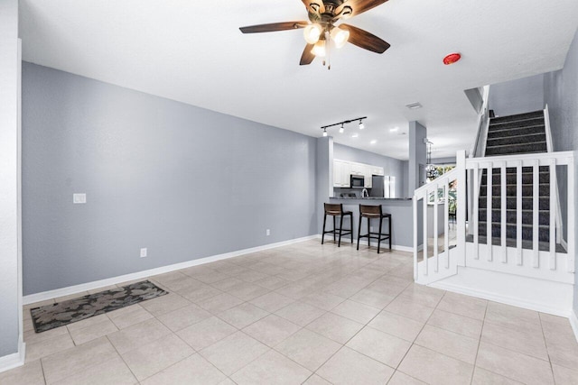 interior space featuring ceiling fan and light tile patterned floors