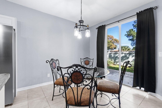 tiled dining room with a wealth of natural light and a notable chandelier