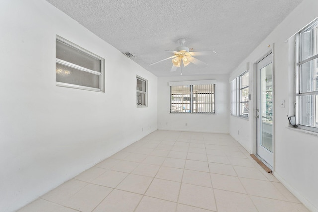 unfurnished sunroom featuring ceiling fan