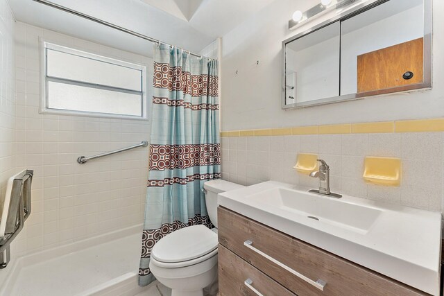 bathroom featuring a shower with shower curtain, vanity, toilet, and tile walls