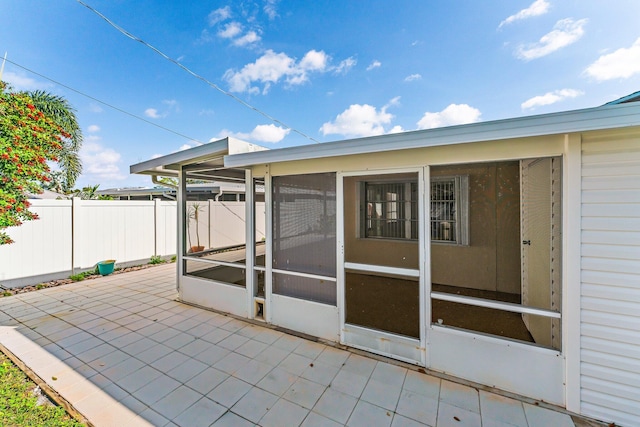 view of patio / terrace featuring a sunroom