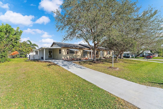 single story home featuring a front lawn and a carport