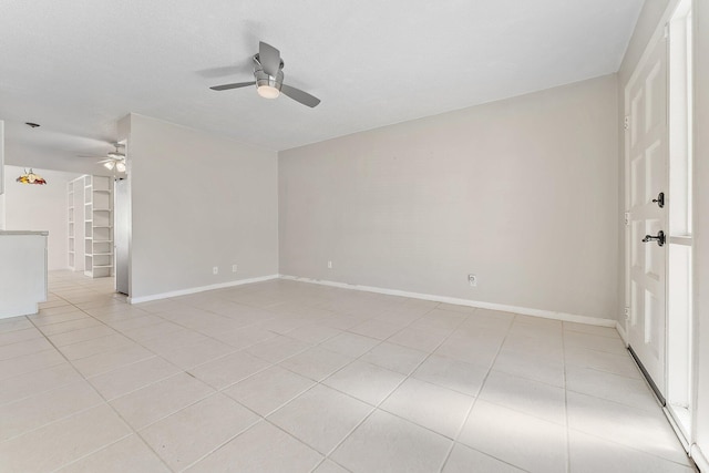 tiled empty room featuring ceiling fan