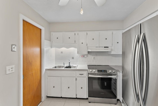 kitchen with white cabinets, sink, decorative backsplash, a textured ceiling, and stainless steel appliances