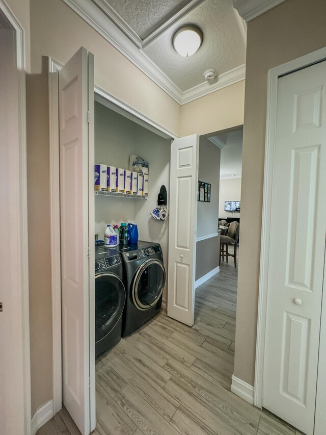 bedroom featuring a tray ceiling, ceiling fan, light hardwood / wood-style flooring, and ornamental molding