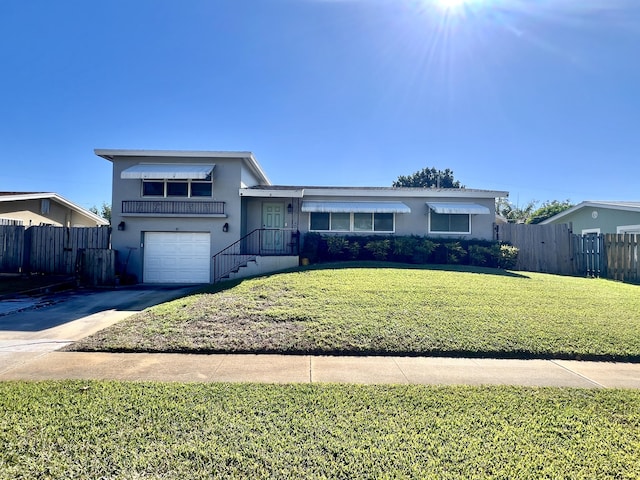 view of front of property with a front yard and a garage