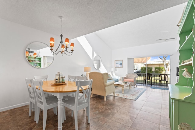 dining area with tile patterned floors, a textured ceiling, and a chandelier