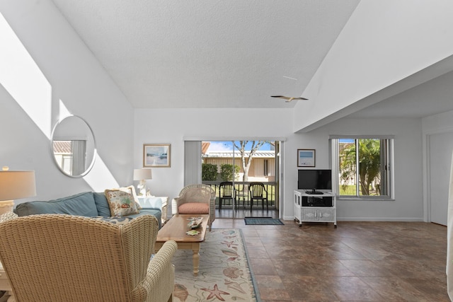 living room featuring a textured ceiling and high vaulted ceiling