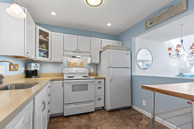 kitchen featuring pendant lighting, white appliances, white cabinets, sink, and a notable chandelier