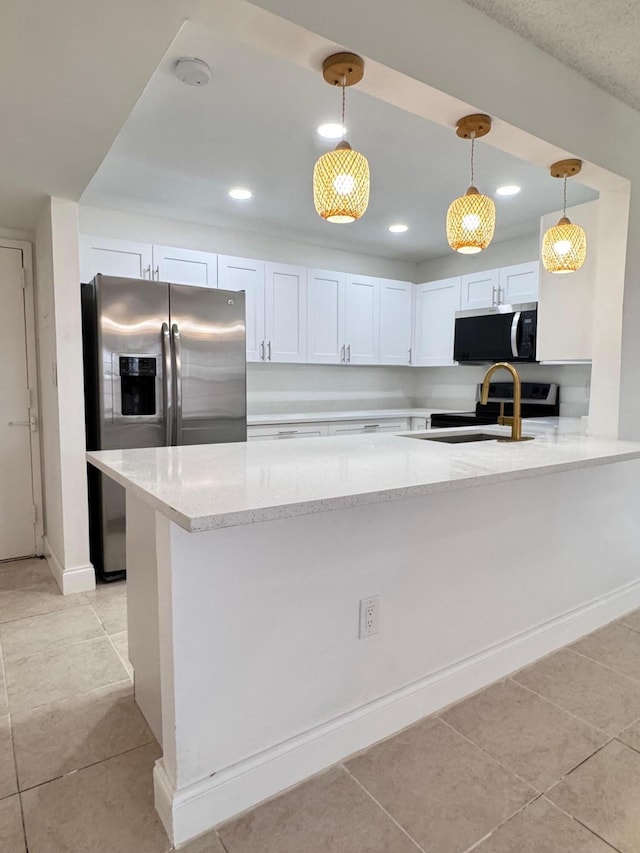 kitchen with kitchen peninsula, light stone counters, stainless steel appliances, white cabinets, and hanging light fixtures