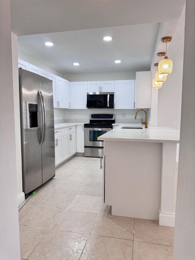 kitchen with white cabinets, sink, light stone countertops, decorative light fixtures, and stainless steel appliances