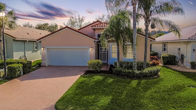 view of front of property featuring a garage and a yard