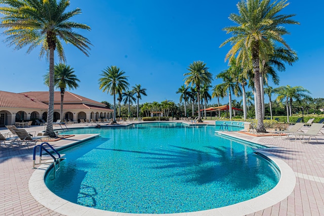 view of swimming pool featuring a patio and a water slide