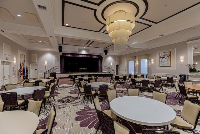 dining room with beamed ceiling, ornamental molding, coffered ceiling, and a chandelier