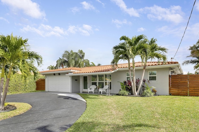 ranch-style home featuring a front yard and a garage