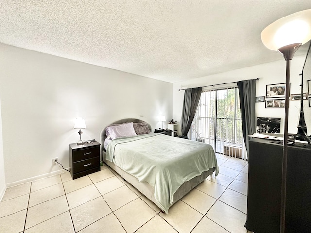 bedroom featuring light tile patterned floors and a textured ceiling